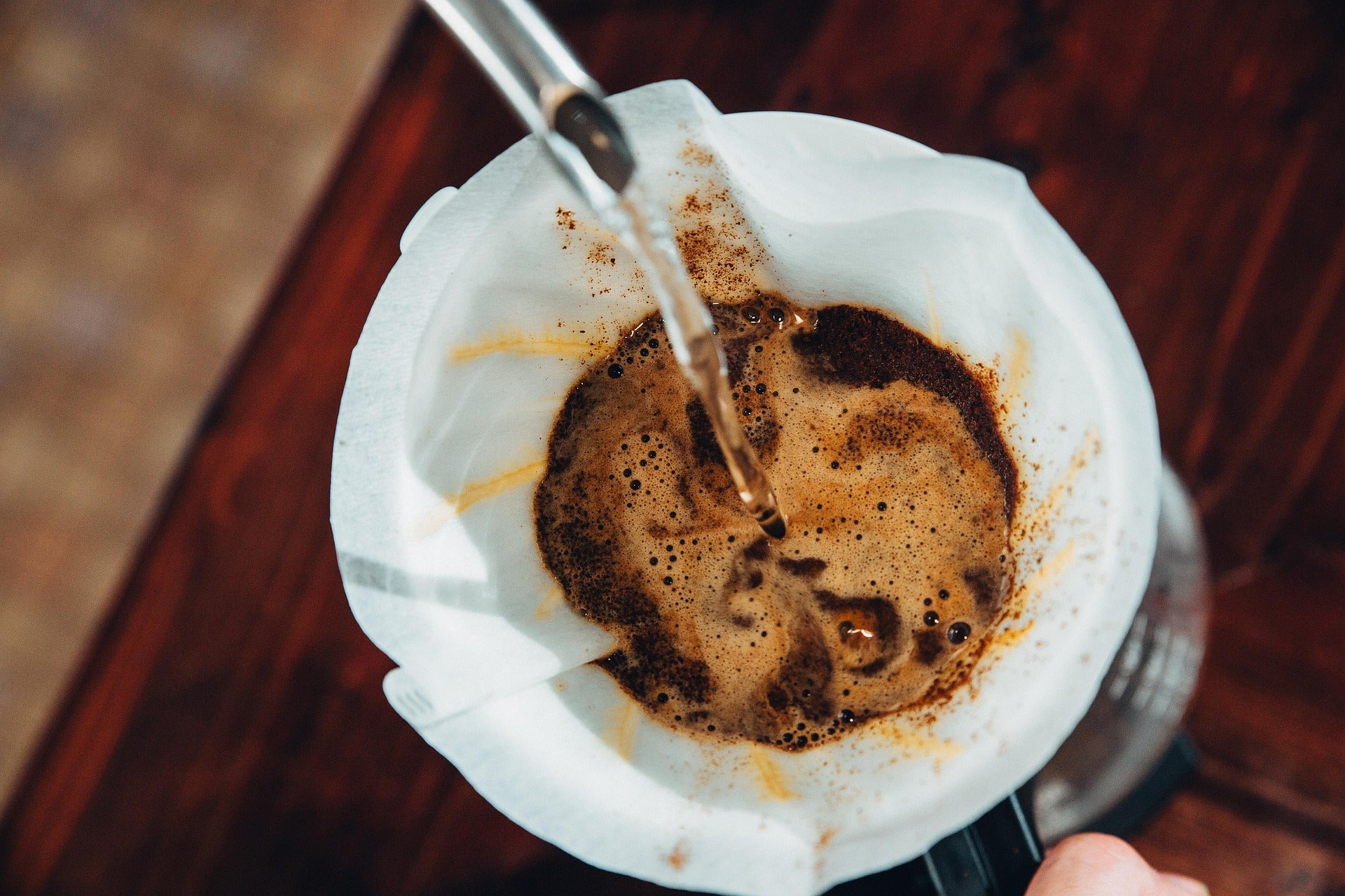 Filterkaffee wird in eine Kaffeekanne aufgegossen.